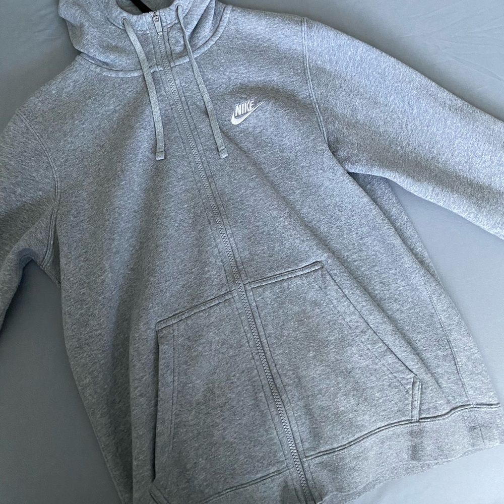 Gray zip up Nike hoodie.